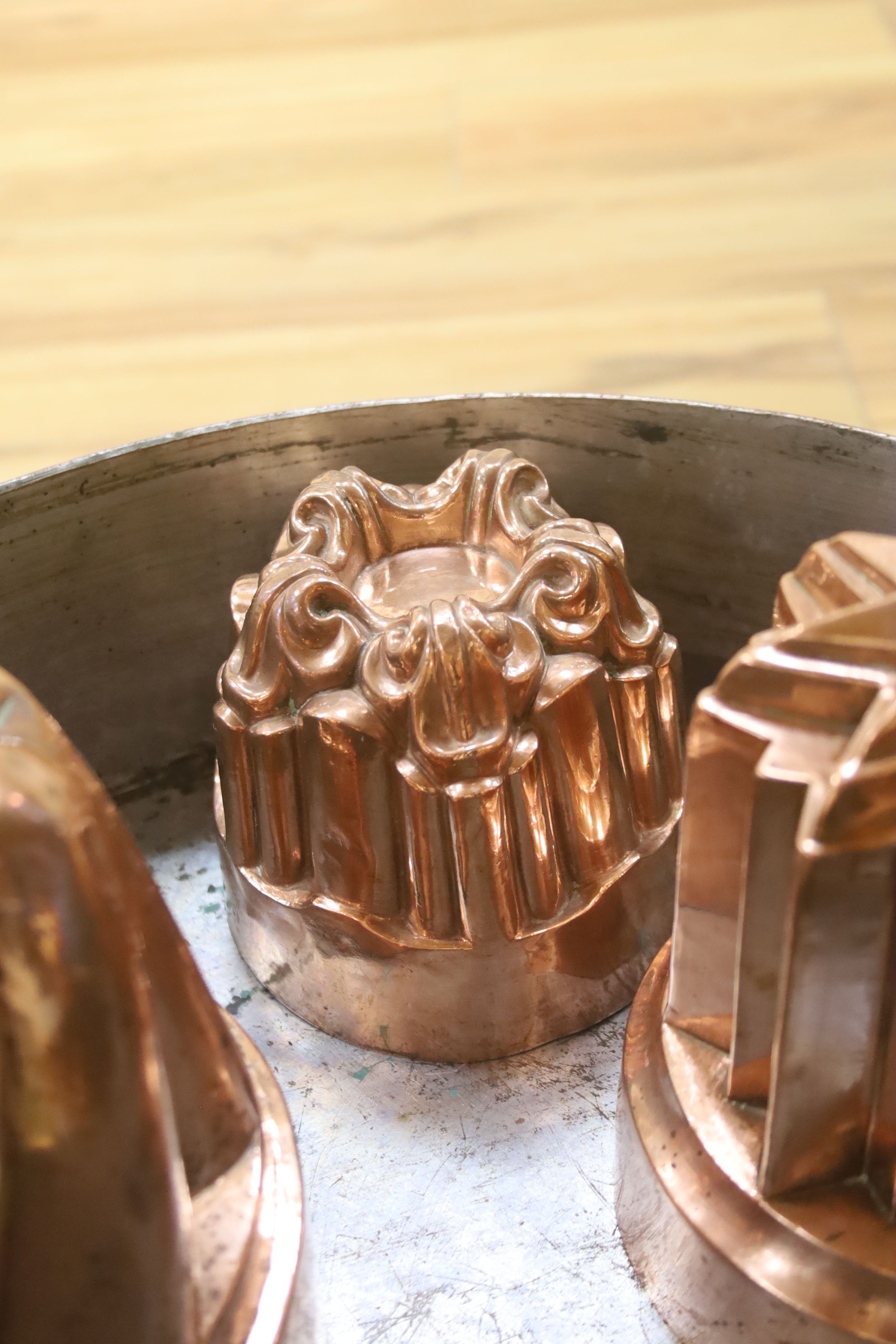 A Victorian Benham & Froude copper jelly mould, 11cm high, two others, 16.5cm high and a copper preserving pan